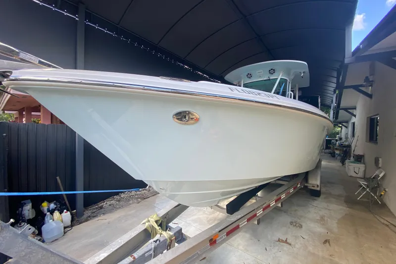 Slide: The Image of 2006 Everglades 290 Center Console boat on trailer in covered storage area. - 11