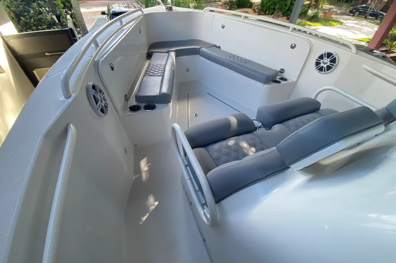 Slide: The Image of 2006 Everglades 290 Center Console boat interior with cushioned seating and cup holders. - 16
