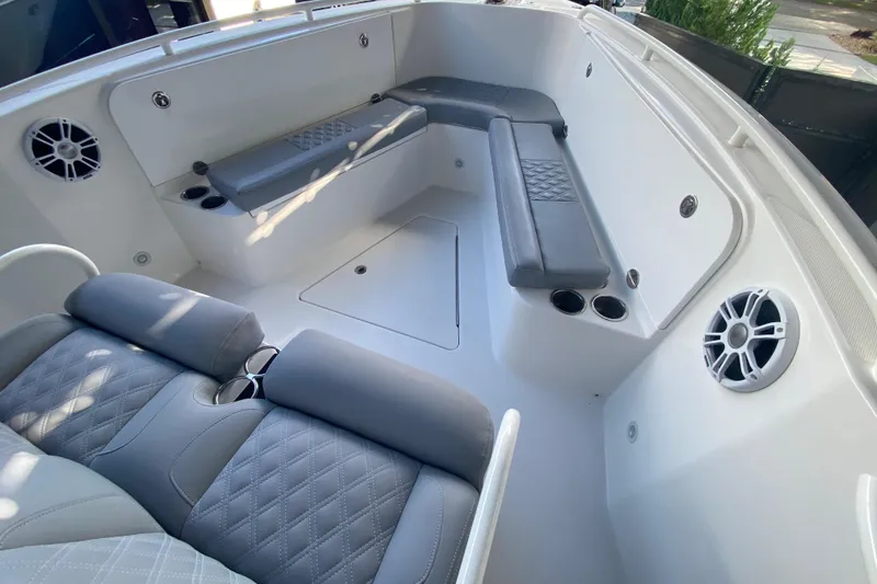 Slide: The Image of 2006 Everglades 290 Center Console boat interior with gray seating and cup holders. - 17