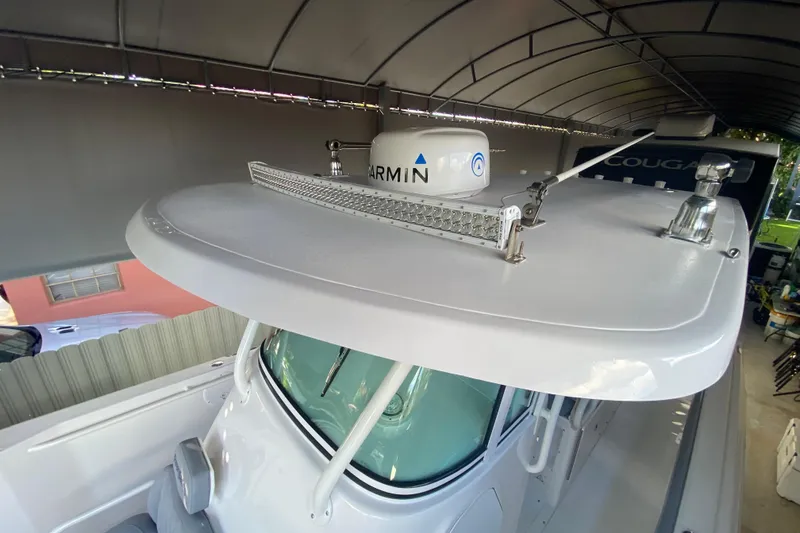 Slide: The Image of 2006 Everglades 290 Center Console boat with radar and light bar under a canopy. - 19
