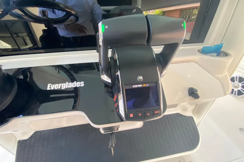 Slide: The Image of Control panel of 2006 Everglades 290 Center Console boat with steering wheel and throttle. - 25