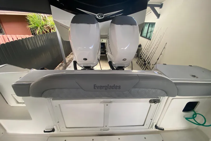 Slide: The Image of 2006 Everglades 290 Center Console boat with dual outboard engines and fishing rods. - 27