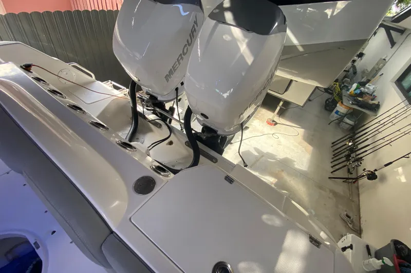 Slide: The Image of 2006 Everglades 290 Center Console boat with dual Mercury engines in a garage setting. - 30