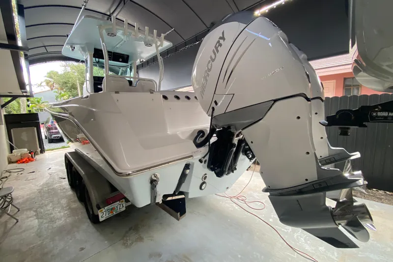 Slide: The Image of 2006 Everglades 290 Center Console boat with Mercury outboard engine in a covered area. - 31