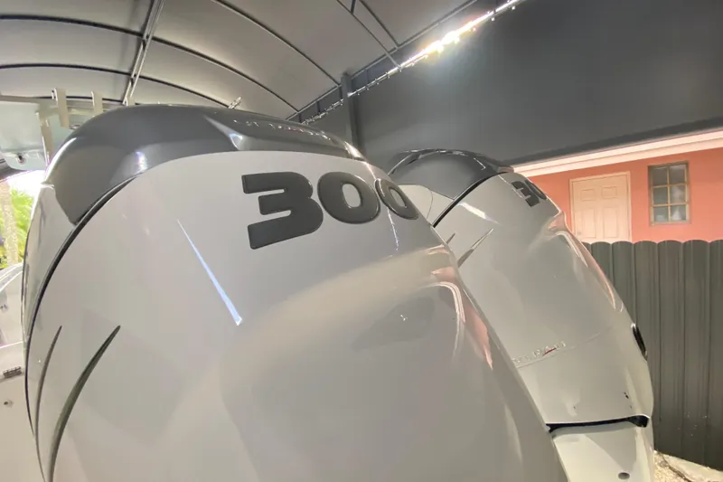 Slide: The Image of Twin 300 horsepower engines on a 2006 Everglades 290 Center Console boat. - 34