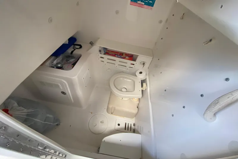 Slide: The Image of Interior of 2006 Everglades 290 Center Console boat with compact marine toilet. - 40