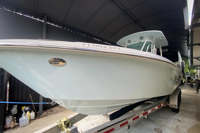 Slide: The Image of 2006 Everglades 290 Center Console boat on trailer under canopy. - 7