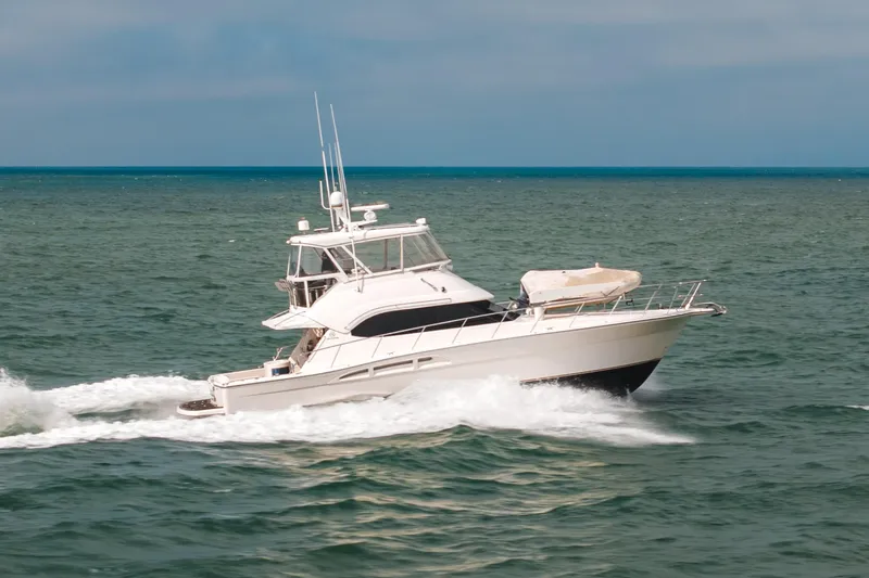 Slide: The Image of 2005 Riviera 47 Open Flybridge yacht cruising on the ocean. - 0