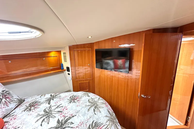 Slide: The Image of 2005 Riviera 47 Open Flybridge cabin with wooden interior and cozy bunk beds. - 15