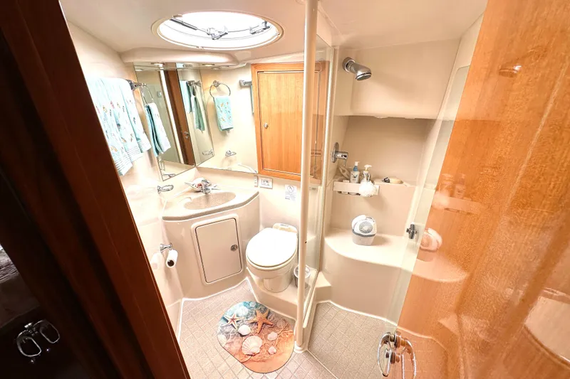 Slide: The Image of Luxurious 2005 Riviera 47 Open Flybridge cabin with cozy bed and elegant wood finishes. - 16