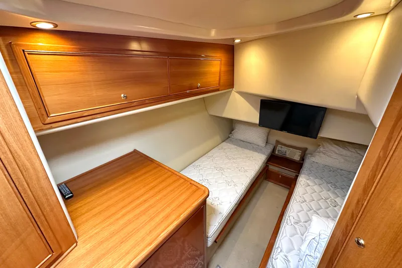 Slide: The Image of Bathroom interior of 2005 Riviera 47 Open Flybridge yacht, featuring shower, toilet, and wooden cabinetry. - 17