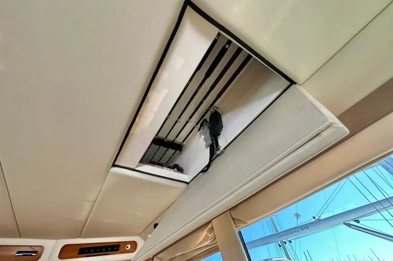 Slide: The Image of Luxurious cabin interior of 2005 Riviera 47 Open Flybridge yacht with TV and floral bedding. - 18