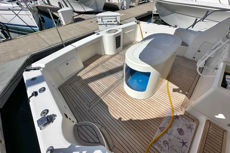 Slide: The Image of Luxurious 2005 Riviera 47 Open Flybridge yacht interior with seating and marina view. - 28