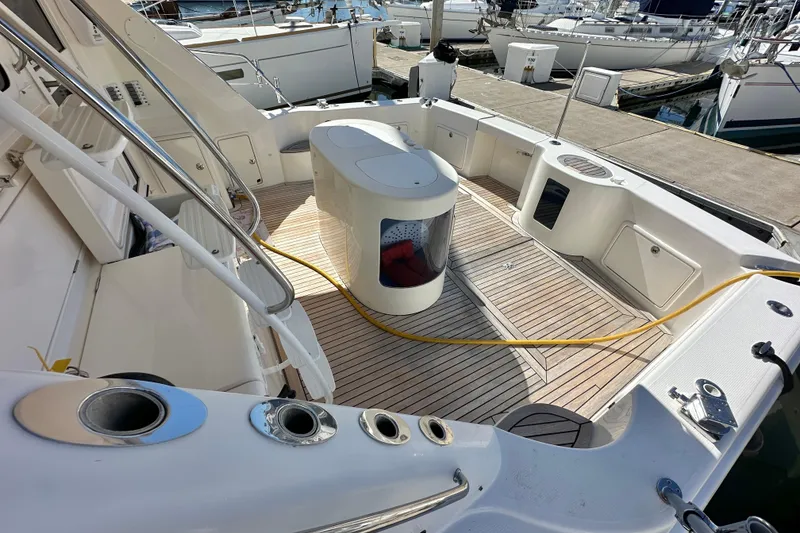 Slide: The Image of Luxurious 2005 Riviera 47 Open Flybridge yacht interior with helm, seating, and marina view. - 29