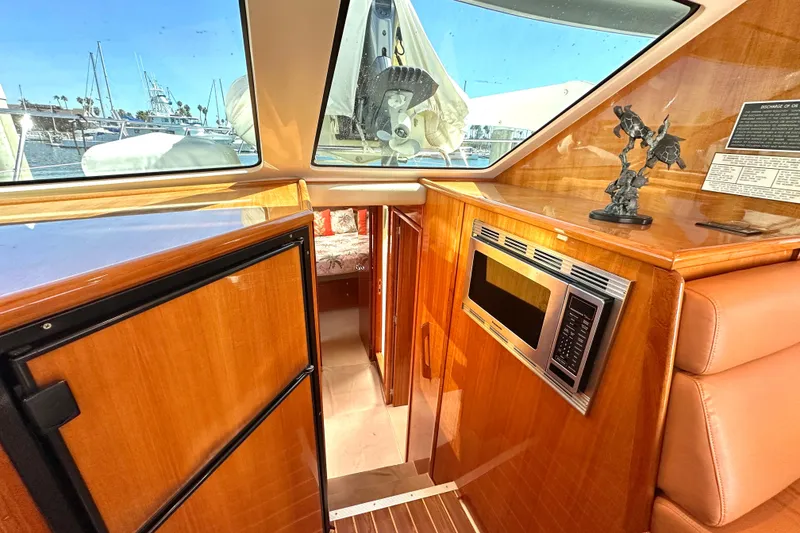 Slide: The Image of Luxurious interior of 2005 Riviera 47 Open Flybridge with leather seating and nautical decor. - 8