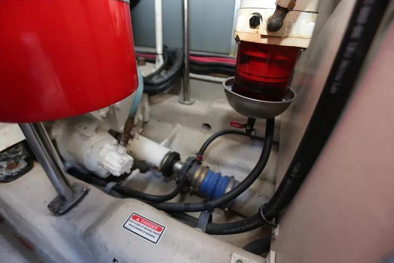 Slide: The Image of Engine compartment of 2004 Sea Ray 420 Sedan Bridge with visible components and warning label. - 109