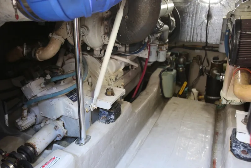 Slide: The Image of Engine room of 2004 Sea Ray 420 Sedan Bridge, showcasing mechanical components and piping. - 111