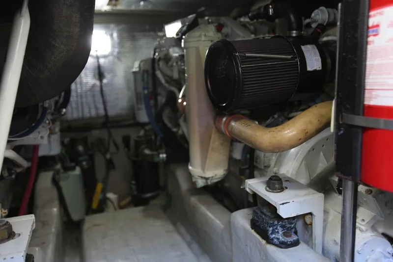 Slide: The Image of Engine room of 2004 Sea Ray 420 Sedan Bridge with visible components and equipment. - 112