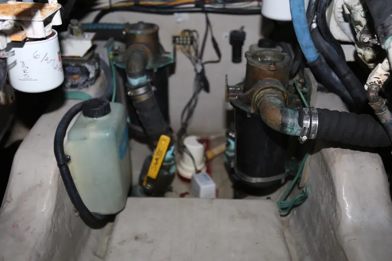 Slide: The Image of Engine compartment of a 2004 Sea Ray 420 Sedan Bridge, showing hoses and components. - 114