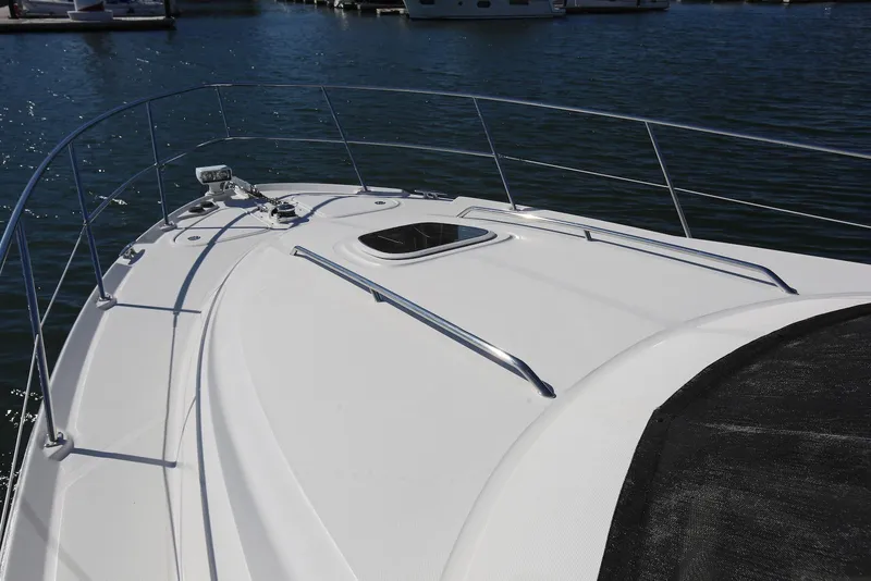 Slide: The Image of 2004 Sea Ray 420 Sedan Bridge yacht deck with railing, docked in marina. - 29