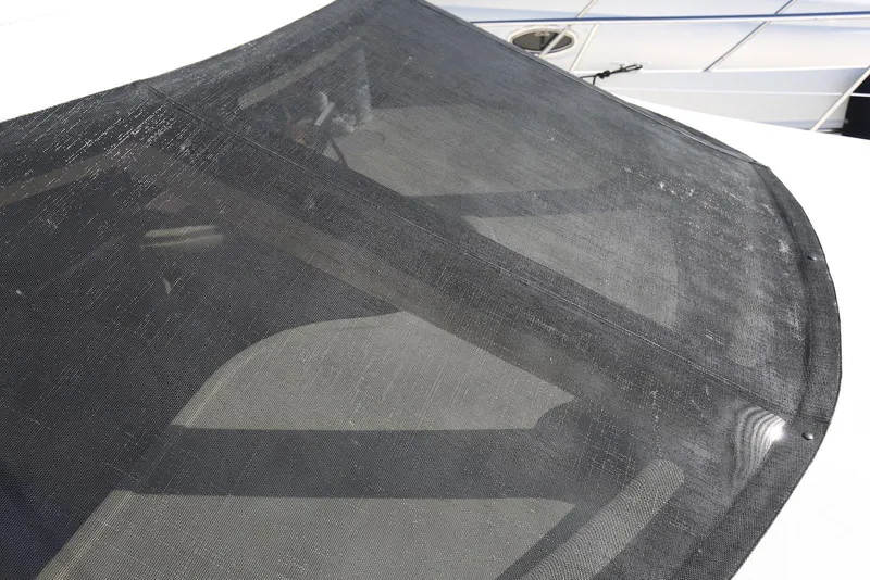 Slide: The Image of 2004 Sea Ray 420 Sedan Bridge windshield with protective mesh cover. - 32