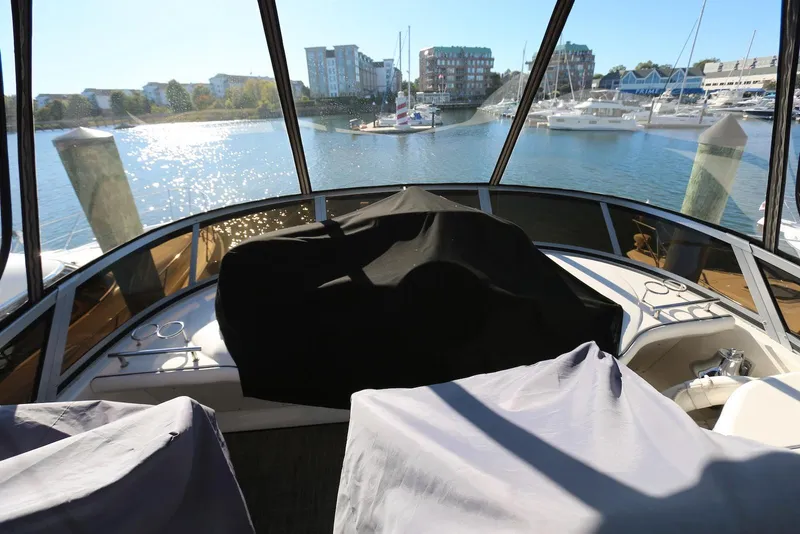 Slide: The Image of 2004 Sea Ray 420 Sedan Bridge interior with marina view through large windows. - 34