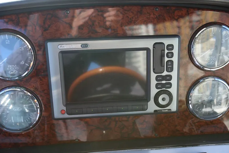 Slide: The Image of Dashboard of a 2004 Sea Ray 420 Sedan Bridge with Raymarine E90w display. - 43