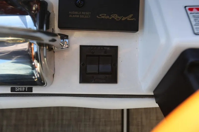 Slide: The Image of Control panel of a 2004 Sea Ray 420 Sedan Bridge boat with shift lever. - 47