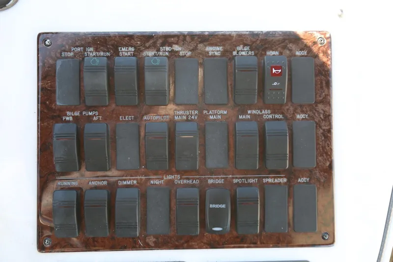 Slide: The Image of Control panel of a 2004 Sea Ray 420 Sedan Bridge boat with labeled switches. - 48