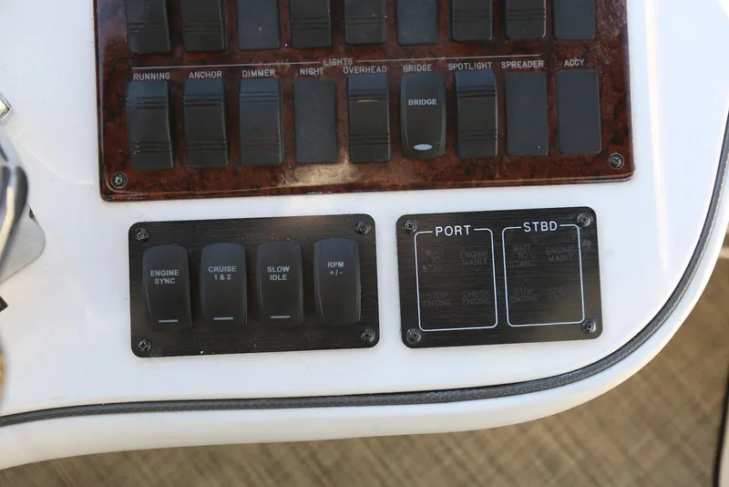 Slide: The Image of Control panel of a 2004 Sea Ray 420 Sedan Bridge yacht with labeled switches. - 49