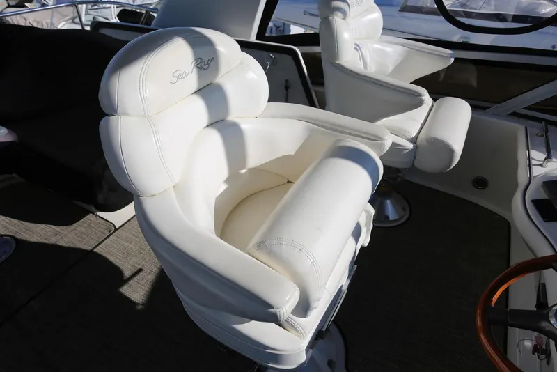 Slide: The Image of Luxurious white captain's chairs on 2004 Sea Ray 420 Sedan Bridge yacht. - 55
