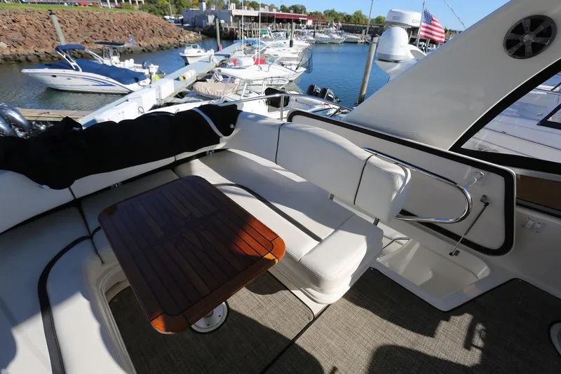 Slide: The Image of 2004 Sea Ray 420 Sedan Bridge yacht interior with seating and wooden table. - 58