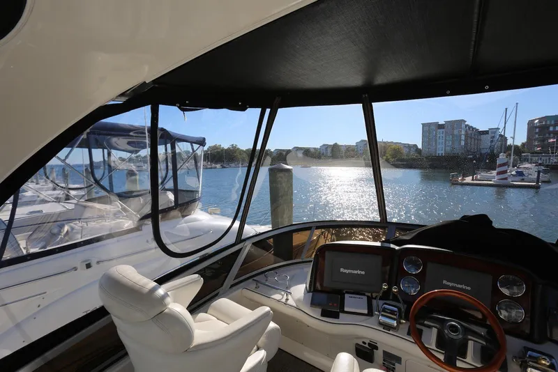 Slide: The Image of Interior view of 2004 Sea Ray 420 Sedan Bridge yacht with marina backdrop. - 60