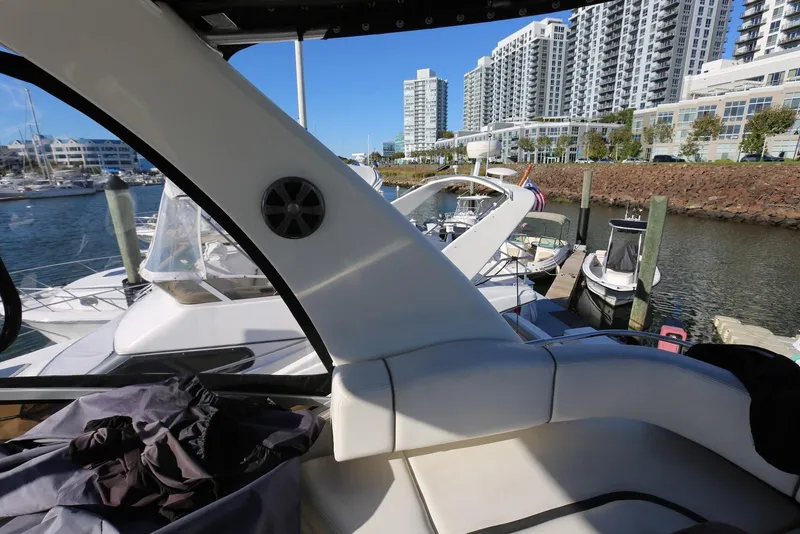 Slide: The Image of 2004 Sea Ray 420 Sedan Bridge docked in marina with cityscape background. - 63
