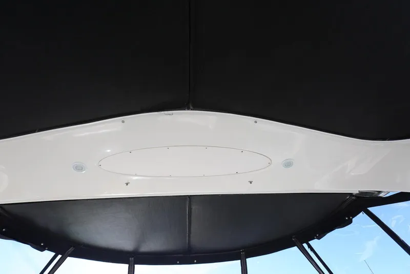 Slide: The Image of 2004 Sea Ray 420 Sedan Bridge interior ceiling view with black and white design. - 64