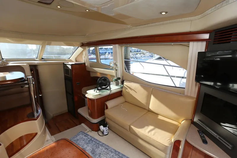 Slide: The Image of Luxurious interior of 2004 Sea Ray 420 Sedan Bridge yacht with beige seating and modern amenities. - 67