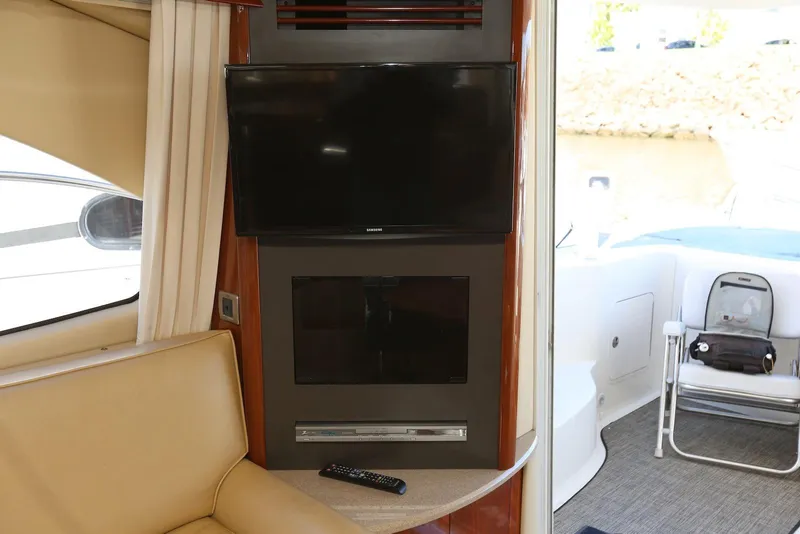 Slide: The Image of Interior of 2004 Sea Ray 420 Sedan Bridge with TV and seating area. - 71