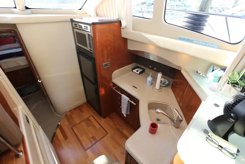 Slide: The Image of 2004 Sea Ray 420 Sedan Bridge yacht interior with kitchenette and wood flooring. - 72