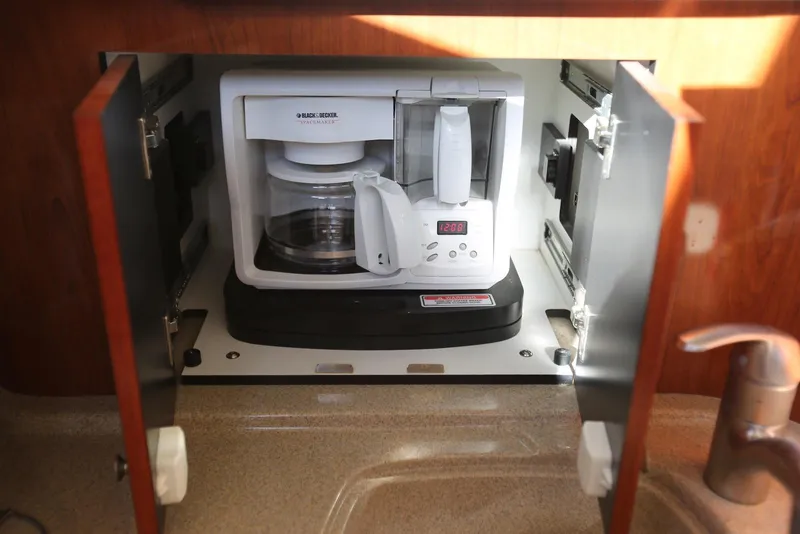 Slide: The Image of Built-in coffee maker on 2004 Sea Ray 420 Sedan Bridge yacht, with wooden cabinetry. - 78