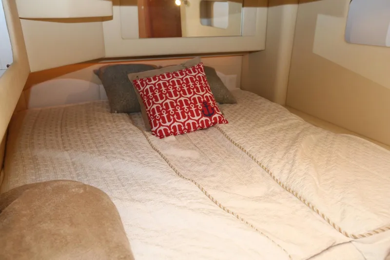 Slide: The Image of Cozy bedroom interior of 2004 Sea Ray 420 Sedan Bridge yacht with decorative pillows. - 80