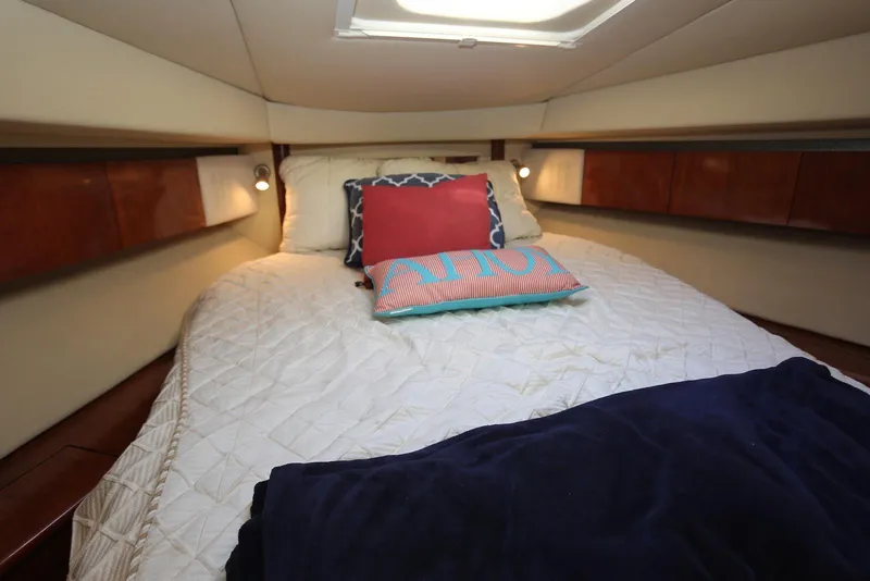 Slide: The Image of Luxurious cabin interior of 2004 Sea Ray 420 Sedan Bridge yacht with cozy bedding. - 83