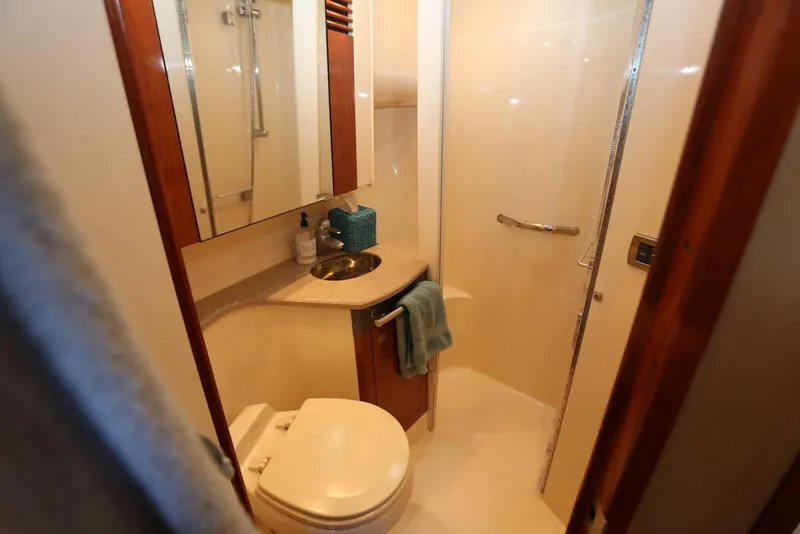 Slide: The Image of Luxurious bathroom in 2004 Sea Ray 420 Sedan Bridge yacht, featuring shower and vanity. - 86
