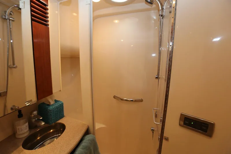 Slide: The Image of Bathroom interior of 2004 Sea Ray 420 Sedan Bridge yacht, featuring shower and sink. - 87