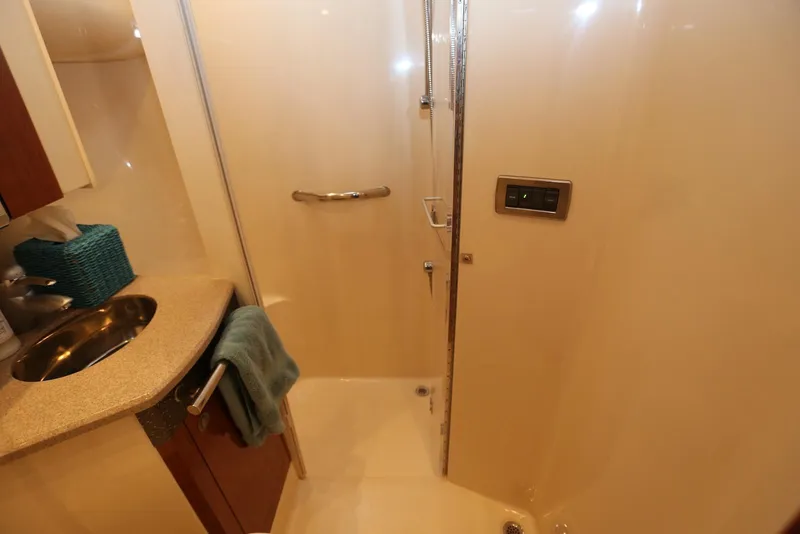 Slide: The Image of Bathroom interior of 2004 Sea Ray 420 Sedan Bridge yacht, featuring shower and sink. - 89