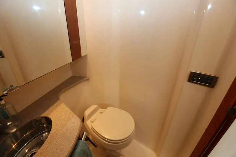 Slide: The Image of Bathroom interior of 2004 Sea Ray 420 Sedan Bridge yacht, featuring toilet and sink. - 93