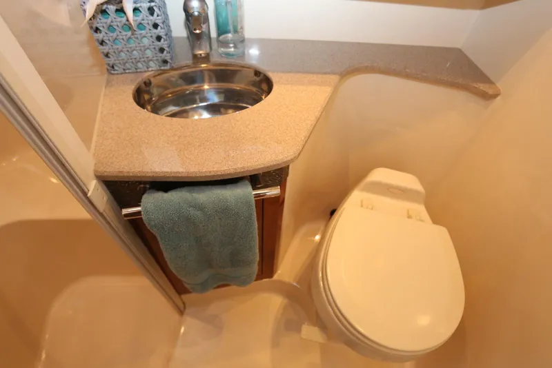 Slide: The Image of 2004 Sea Ray 420 Sedan Bridge bathroom with sink and toilet. - 95