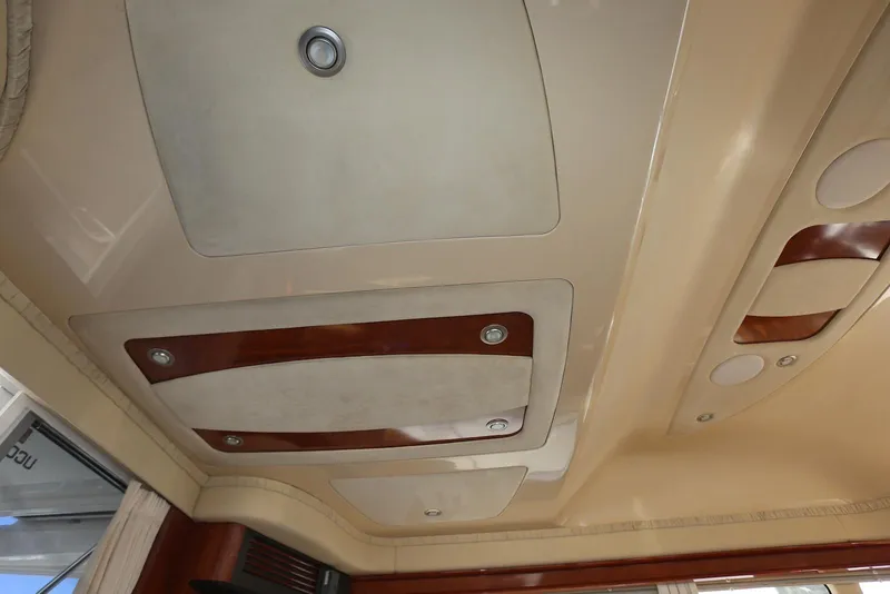 Slide: The Image of Interior ceiling of a 2004 Sea Ray 420 Sedan Bridge yacht, featuring elegant wood accents. - 96