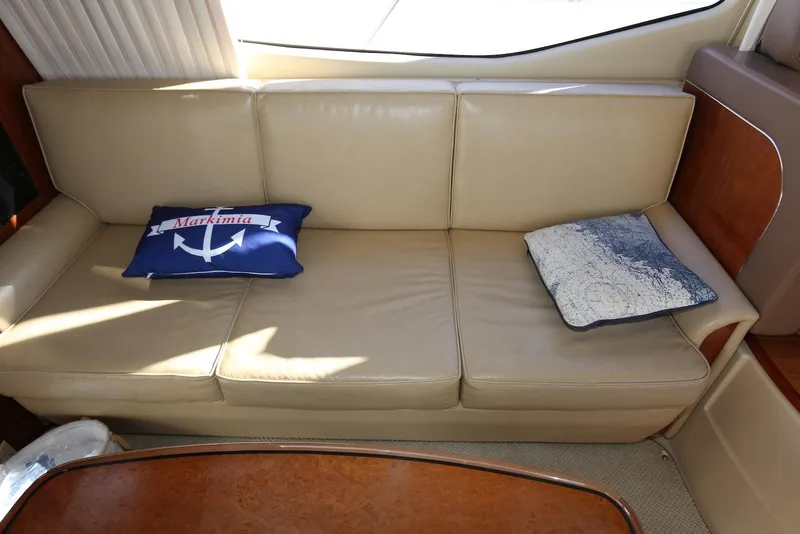 Slide: The Image of Luxurious beige leather sofa in 2004 Sea Ray 420 Sedan Bridge yacht interior. - 98