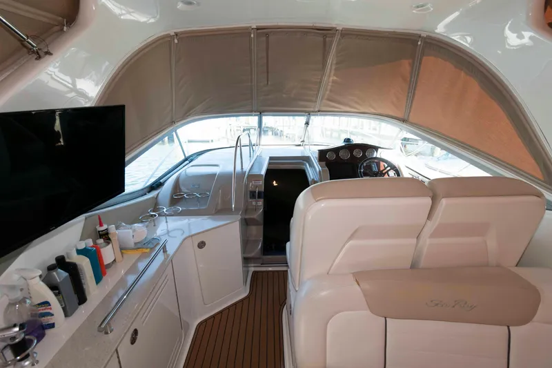 Slide: The Image of 2009 Sea Ray 310 Sundancer interior with helm, seating, and amenities. - 3