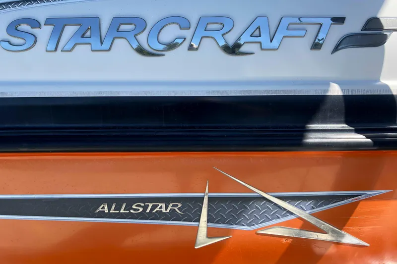Slide: The Image of 2018 Starcraft SVX 190 OB boat with "Allstar" branding on orange and white exterior. - 10